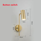 Bouton interrupteur doré / Blanc froid (5 500-7 000 K).